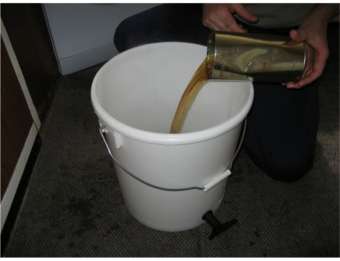 brewing pouring can into fermenter